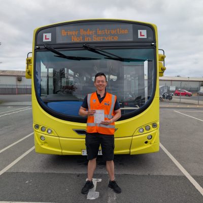 New bus driver with his pass certificate in front of a Warrington's Own bus.